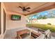 Comfortable covered patio seating with a ceiling fan and backyard view at 21640 N 48Th St, Phoenix, AZ 85054