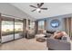Bright living room featuring a comfortable sectional sofa, light hardwood floors, and patio access at 21640 N 48Th St, Phoenix, AZ 85054