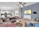 Open-concept living room with modern furnishings, a ceiling fan, and light wood floors at 21640 N 48Th St, Phoenix, AZ 85054