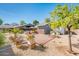 Landscaped backyard with brick patio, desert plants, and a covered grilling station at 220 W San Juan Ave, Phoenix, AZ 85013