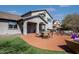 The backyard has a covered patio, a lush green lawn, and comfortable seating for relaxing or outdoor dining at 2423 W Bramble Berry Ln, Phoenix, AZ 85085