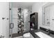 Modern bathroom with unique black-and-white patterned shower tiles, sleek vanity, and stylish fixtures for a contemporary design at 2423 W Bramble Berry Ln, Phoenix, AZ 85085