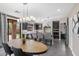 Open concept kitchen featuring gray cabinets, a large center island with barstool seating, and modern pendant lighting at 2423 W Bramble Berry Ln, Phoenix, AZ 85085