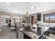 Bright kitchen showcasing a large island with seating, stainless steel appliances, and access to the outdoor living space at 2423 W Bramble Berry Ln, Phoenix, AZ 85085