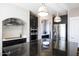 Modern kitchen with stainless steel appliances, dark cabinetry, black granite countertop and attractive white backsplash at 2423 W Bramble Berry Ln, Phoenix, AZ 85085