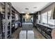 A spacious walk-in closet features custom shelving, an island, and a window, offering ample storage and natural light at 2423 W Bramble Berry Ln, Phoenix, AZ 85085