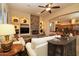 Comfortable living room featuring a stone fireplace, built-in shelves, and open floorplan at 24517 N 77Th St, Scottsdale, AZ 85255