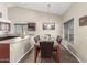 Cozy dining area with a stone-top table, dark wood chairs, and modern décor at 25592 W Pioneer St, Buckeye, AZ 85326