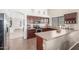 Modern kitchen with stainless steel appliances, dark wood cabinets, and tile backsplash at 25592 W Pioneer St, Buckeye, AZ 85326