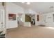 Open concept living room featuring carpet flooring, high ceilings, and neutral paint at 25592 W Pioneer St, Buckeye, AZ 85326