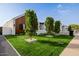 Well-manicured front yard with lush green grass, trimmed trees, and white gravel accents at 2636 N Fiesta St, Scottsdale, AZ 85257