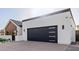 Close-up of the garage door, showcasing its sleek black design and horizontal windows at 2636 N Fiesta St, Scottsdale, AZ 85257