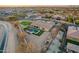 An aerial view of desert home and neighborhood, featuring a large lot with pool and well-maintained landscaping at 3211 E Ian Dr, Phoenix, AZ 85042
