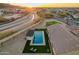 Features a sparkling pool, covered patio, and lush turf with city views at 3211 E Ian Dr, Phoenix, AZ 85042
