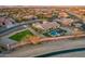 An aerial view of desert home and neighborhood, featuring a large lot with pool and well-maintained landscaping at 3211 E Ian Dr, Phoenix, AZ 85042