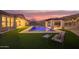 Luxurious backyard features a sparkling pool, covered patio, and well-manicured lawn at 3211 E Ian Dr, Phoenix, AZ 85042