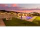 Features a shimmering pool, outdoor seating, and a charming pergola with festive lights at 3211 E Ian Dr, Phoenix, AZ 85042