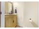 Bathroom features a vanity with carved wood detail and a decorative framed mirror at 3211 E Ian Dr, Phoenix, AZ 85042