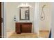 Bathroom featuring a single sink vanity, framed mirror, and tiled shower with a shower curtain at 3211 E Ian Dr, Phoenix, AZ 85042