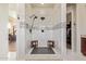 Modern bathroom featuring a large walk-in shower, double showerheads, and neutral colored tile at 3211 E Ian Dr, Phoenix, AZ 85042