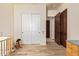 Bedroom showcasing white closet doors and an entryway to another room with wood-look tile flooring at 3211 E Ian Dr, Phoenix, AZ 85042