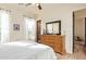 Bedroom with a dresser, decorative mirror, and two windows that allow natural light to come in at 3211 E Ian Dr, Phoenix, AZ 85042