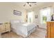 Bright bedroom with wood-look tile flooring, ceiling fan, and windows with sheer curtains at 3211 E Ian Dr, Phoenix, AZ 85042