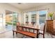 Bright dining area features a rustic table, bench seating and views of mountains and green lawn at 3211 E Ian Dr, Phoenix, AZ 85042