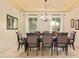 Formal dining room features a modern chandelier, and light-filled windows, perfect for entertaining at 3211 E Ian Dr, Phoenix, AZ 85042