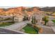 Stunning exterior features stone accents, mature landscaping, and a spacious circular driveway at 3211 E Ian Dr, Phoenix, AZ 85042