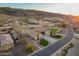 Aerial view of the home's exterior elevation showing the driveway, landscaping and mountain views at 3211 E Ian Dr, Phoenix, AZ 85042