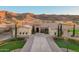 Grand home boasts a striking entrance with stone detailing and manicured landscaping at 3211 E Ian Dr, Phoenix, AZ 85042