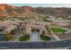 Aerial view of the home's exterior elevation showing the driveway, landscaping and mountain views at 3211 E Ian Dr, Phoenix, AZ 85042