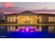 Beautiful backyard view of home and pool illuminated at dusk, creating a peaceful ambiance at 3211 E Ian Dr, Phoenix, AZ 85042