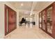 Grand foyer boasts a piano, wine cellar access, and elegant marble flooring, creating a luxurious entrance at 3211 E Ian Dr, Phoenix, AZ 85042