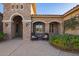Charming front porch with stone accents, elegant seating, and beautiful outdoor lighting at 3211 E Ian Dr, Phoenix, AZ 85042