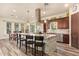 Open kitchen with a granite island, stainless appliances, seating, and an adjacent dining area at 3211 E Ian Dr, Phoenix, AZ 85042