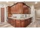 Kitchen area featuring custom wood cabinetry, granite counters, tiled backsplash and built-in oven at 3211 E Ian Dr, Phoenix, AZ 85042