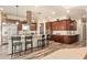 Spacious kitchen boasts stainless steel appliances, central island, and elegant dark wood cabinetry at 3211 E Ian Dr, Phoenix, AZ 85042