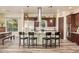 Expansive kitchen with island seating, modern appliances, custom cabinetry, and sleek stainless hood at 3211 E Ian Dr, Phoenix, AZ 85042