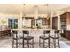 Stylish kitchen with island seating, stainless appliances, ample cabinetry and a modern vent hood at 3211 E Ian Dr, Phoenix, AZ 85042