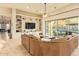 Spacious living room features custom built-ins, a ceiling fan, and sliding doors with views of the pool and backyard at 3211 E Ian Dr, Phoenix, AZ 85042
