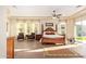 Bright main bedroom with wood floors, ceiling fan, furniture, and large windows with views at 3211 E Ian Dr, Phoenix, AZ 85042
