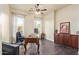 Office featuring hardwood floors, large windows, and wood cabinets and desk for a comfortable workspace at 3211 E Ian Dr, Phoenix, AZ 85042