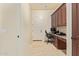 Well-lit office with built-in desk and storage, plus a door leading to the outside at 3211 E Ian Dr, Phoenix, AZ 85042
