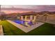 Illuminated pool and patio with mountain views offering a tranquil backyard atmosphere at 3211 E Ian Dr, Phoenix, AZ 85042