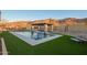 Inviting pool area with water features, a shaded pergola, and mountain backdrop at 3211 E Ian Dr, Phoenix, AZ 85042