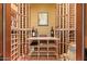 A large wine cellar offers extensive custom storage for wine bottles and accessories, perfect for the wine enthusiast at 3211 E Ian Dr, Phoenix, AZ 85042