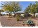 A beautifully landscaped front yard with desert plants and trees creates a welcoming approach to this charming home at 3302 W Tonto Ln, Phoenix, AZ 85027