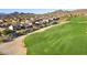 Aerial view of houses in a desert community on a golf course with mountains in the background at 3517 N Paseo Del Sol --, Mesa, AZ 85207